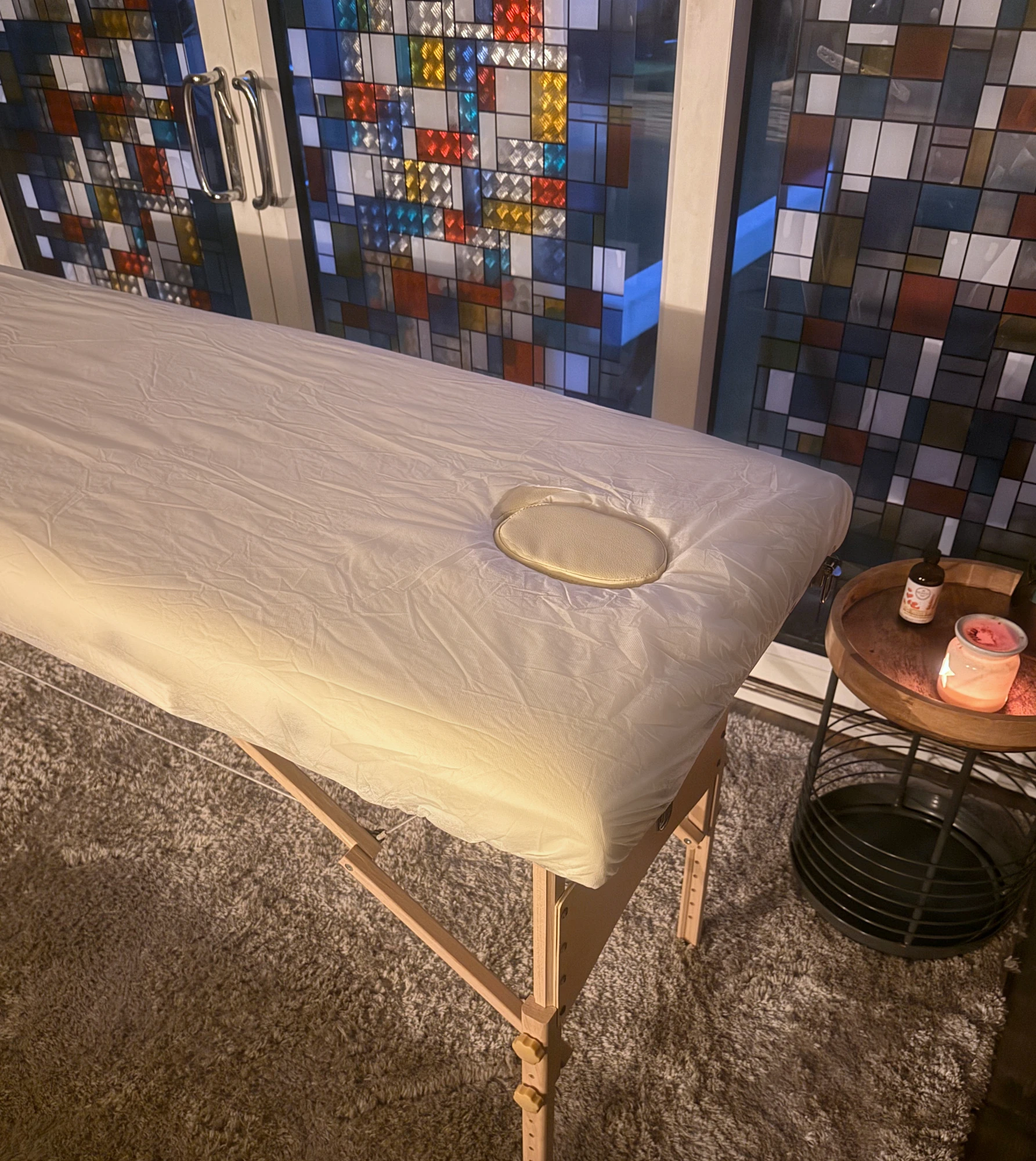 An evening view of the real treatment table and stained-glass doors in the Pontypridd home studio